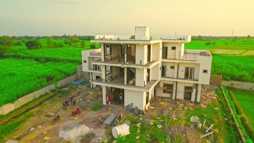 Vrajraj Farms & Retreat surrounded by open green fields in Govardhan